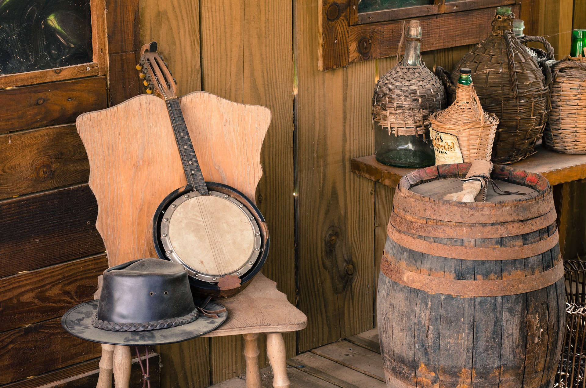 banjo, cowboy hat, bottles and barrel